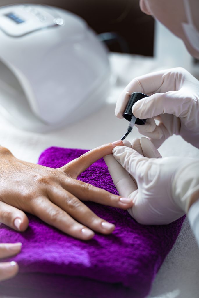 Best Products for Yellow Nail Treatment. Cropped shot of a woman getting her nails done