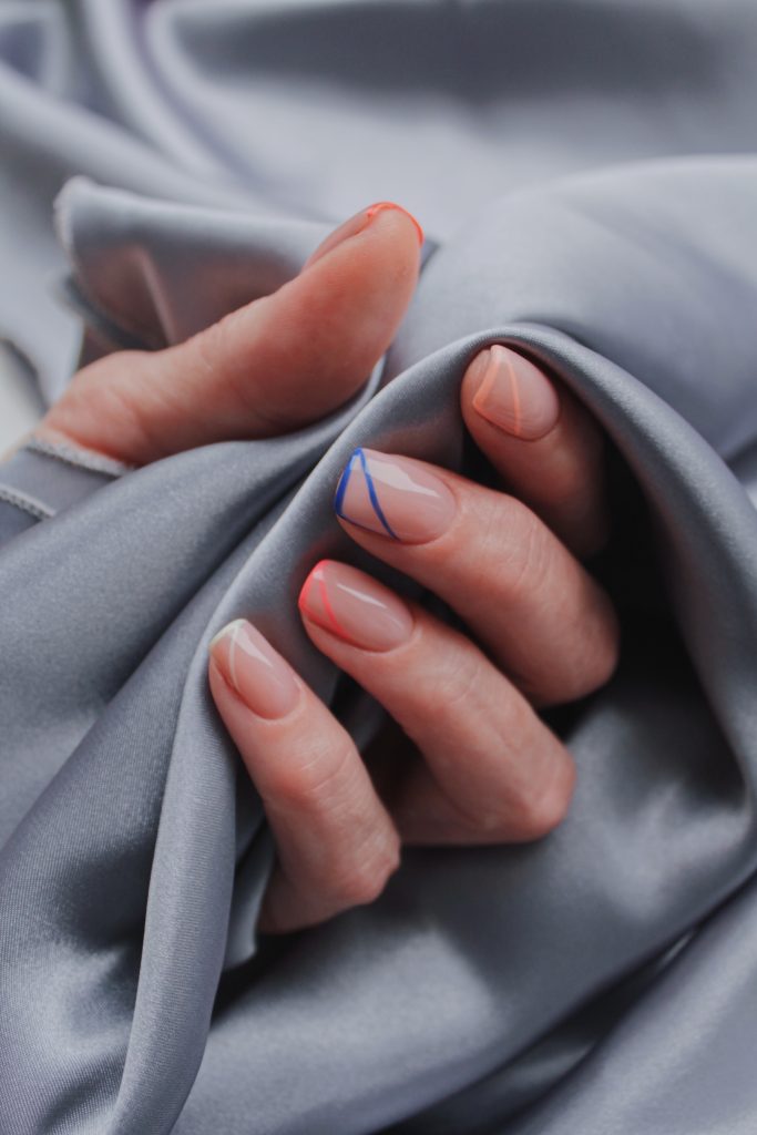 Manicure on a grey fabric textile. Top 2025 Nail Trends That You Need to Know
