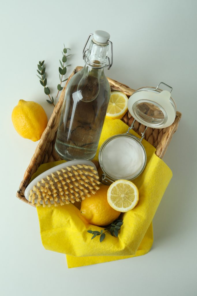 Cleaning concept with eco friendly cleaning tools and lemons on white background. DIY Pre-Styling Cleanser Recipes.