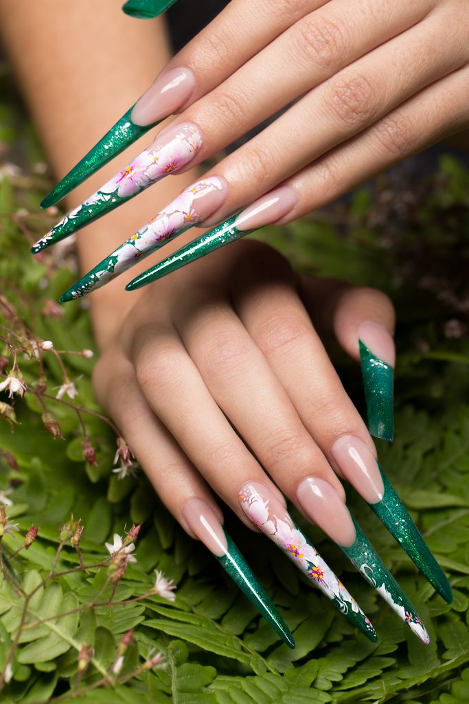 Long beautiful manicure with flowers on female fingers. Nails design. Close-up. Unforgettable Red Carpet Nail Moments. Green nails. long nails.