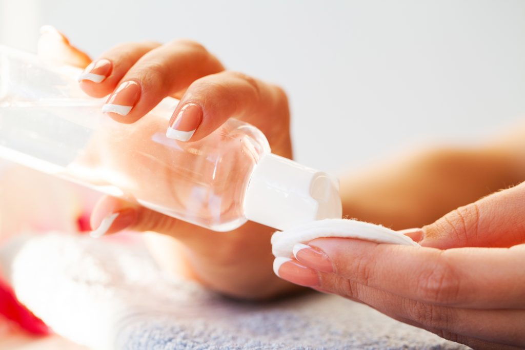 Nails care. Beautiful woman's nails with French manicure, in beauty studio. nail polish removers. nail lacquer. manicure. remove color nails. remove gel polish.