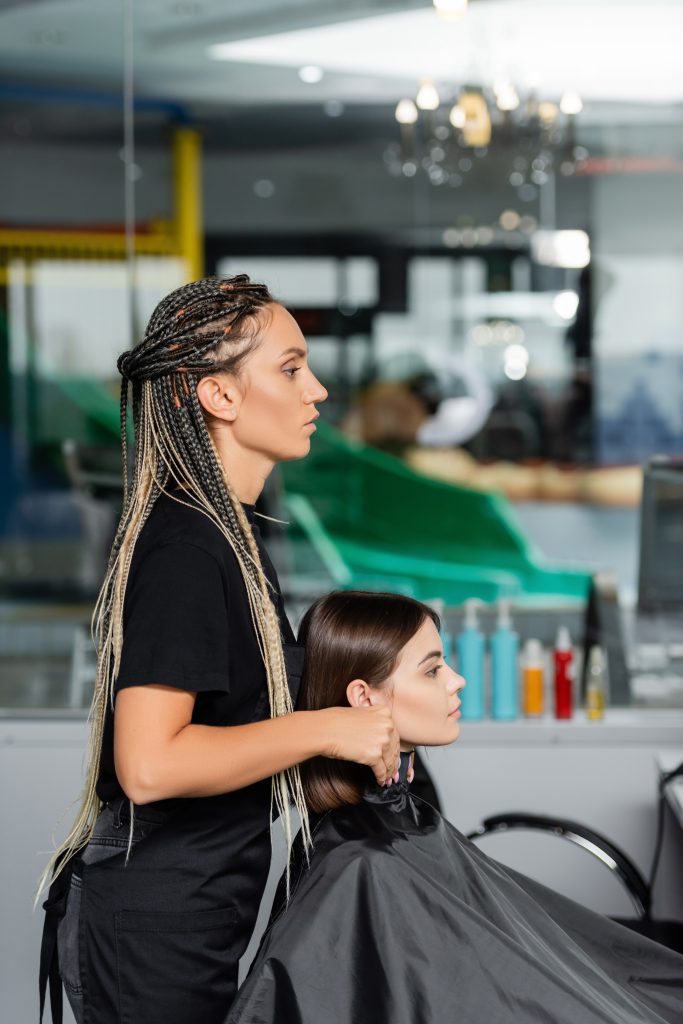 salon job, beauty worker wearing hairdressing collar on female client in beauty salon, hairstyling, Best Haircuts for Each Face Shape.
