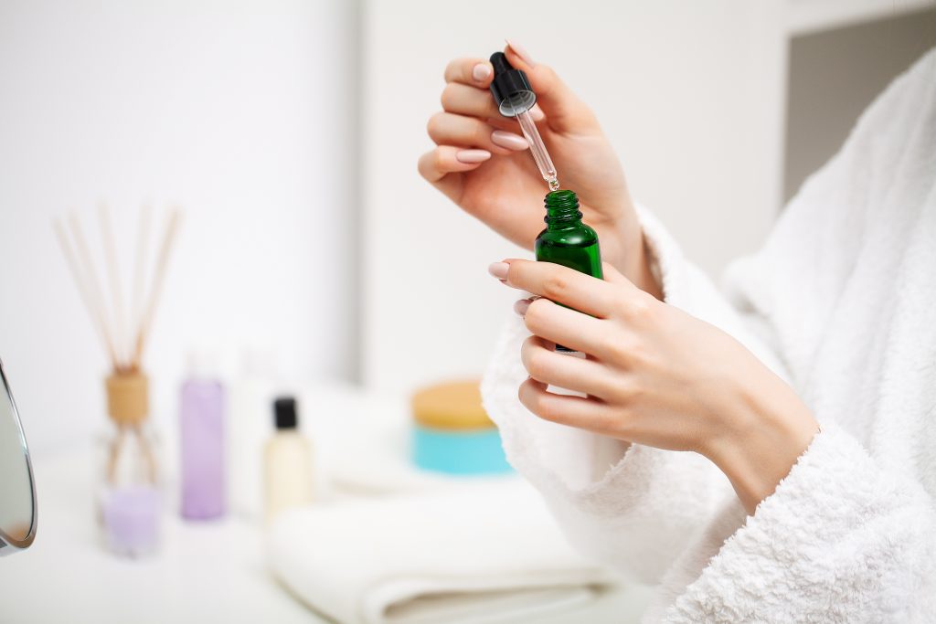 A woman uses a moisturizer to take care of her skin. nail care. 