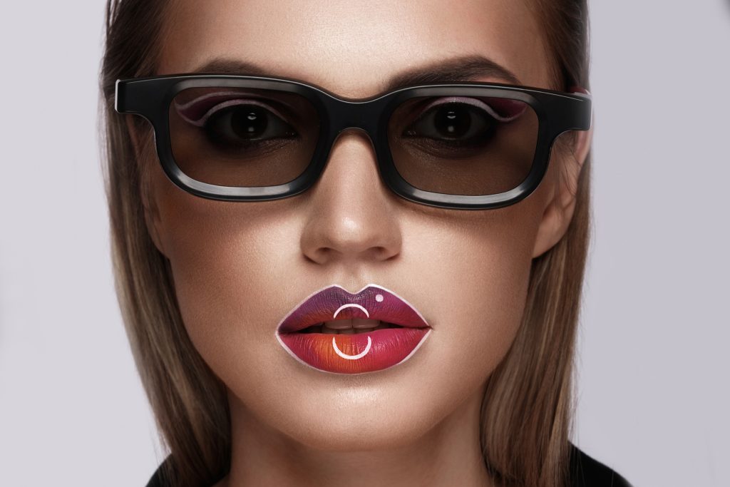 Beautiful caucasian woman with creative makeup and purple lips. Beauty face. Art makeup. 
