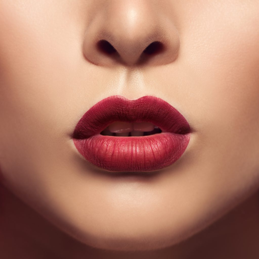 Beautiful lips close up. Red mat lipstick.