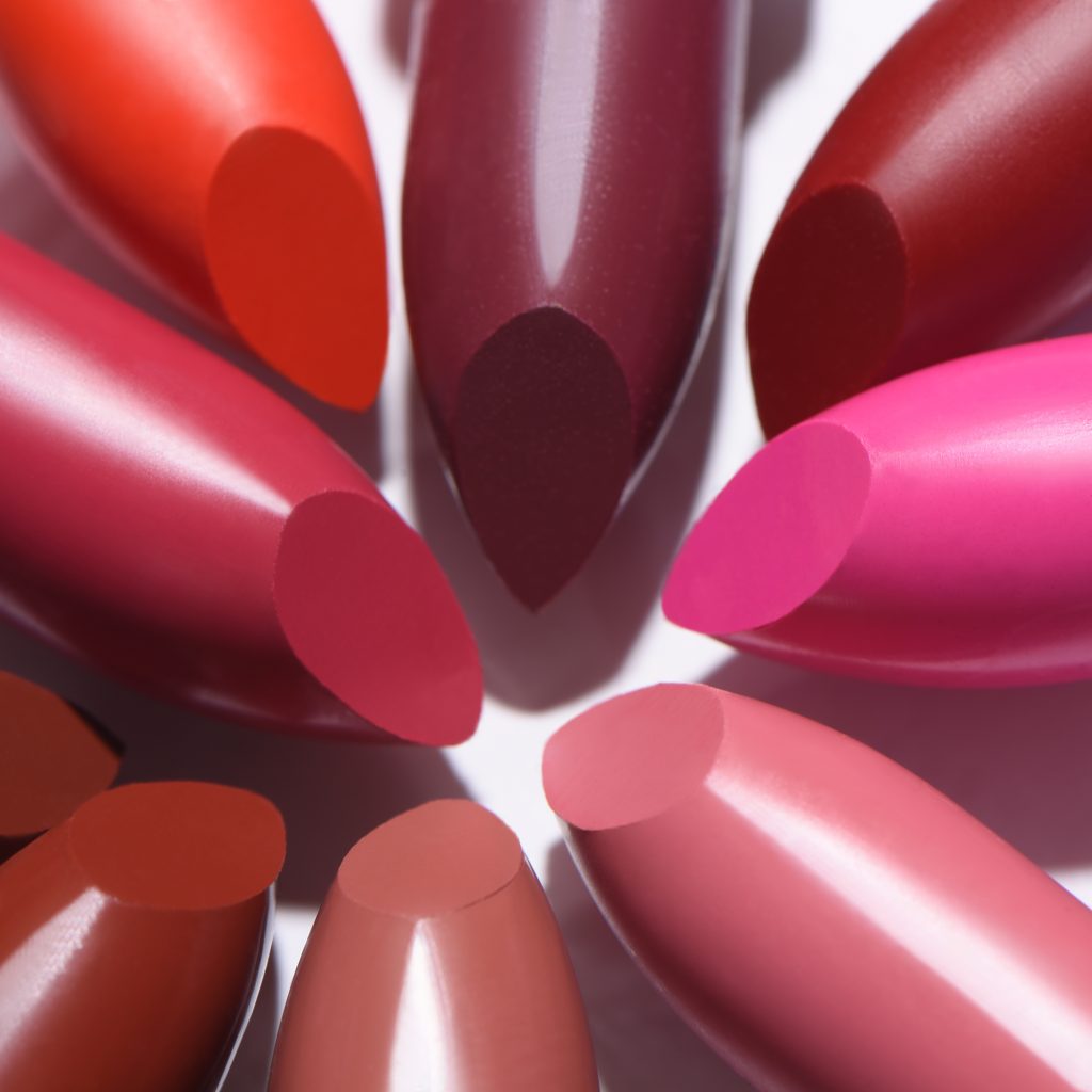 A closeup shot of colorful lipsticks isolated on white background.
