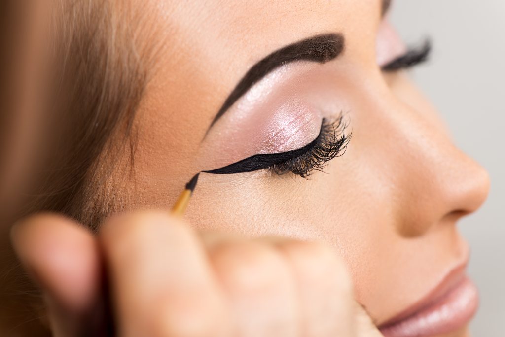 Close up of a make-up artist getting eyeliner to model. Gel Eyeliner: Versatility & Smooth Application.