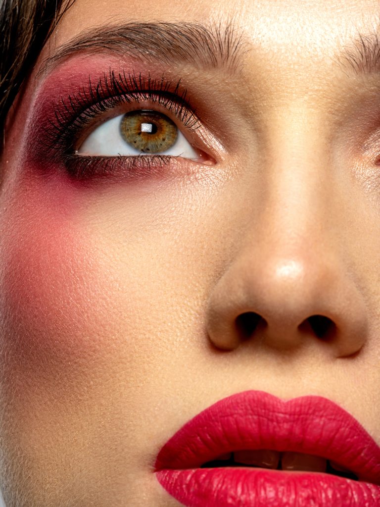 Girl with bright eye makeup. Beautiful fashion woman with  a red lipstick on her lips. Glamour fashion model with vivid make-up. Stylish fashionable concept. Art. Beauty  face.