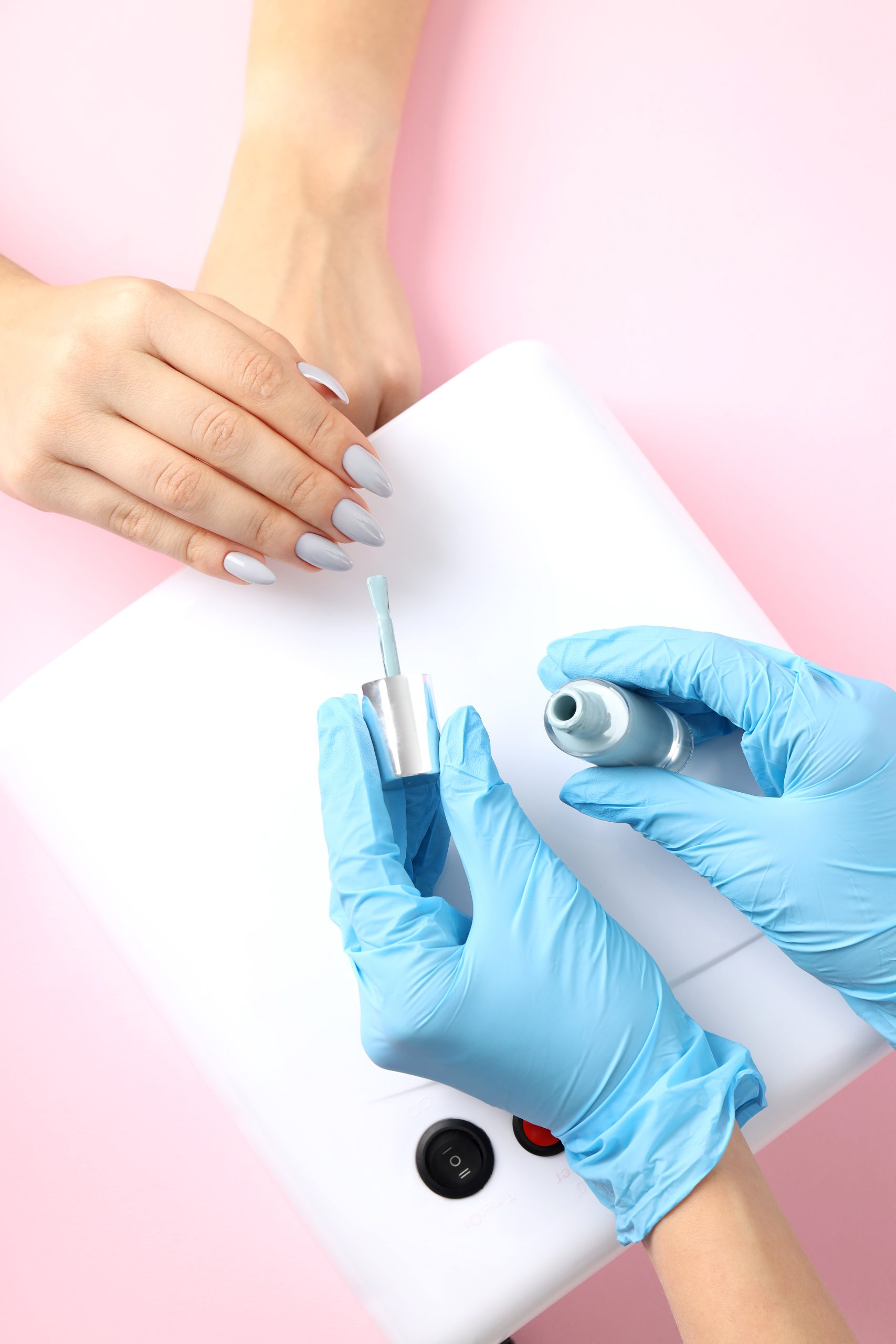 Nail care procedure on pink background, close up. Polygel and Acrylic Extensions | The Hottest Nail Trend Right Now.