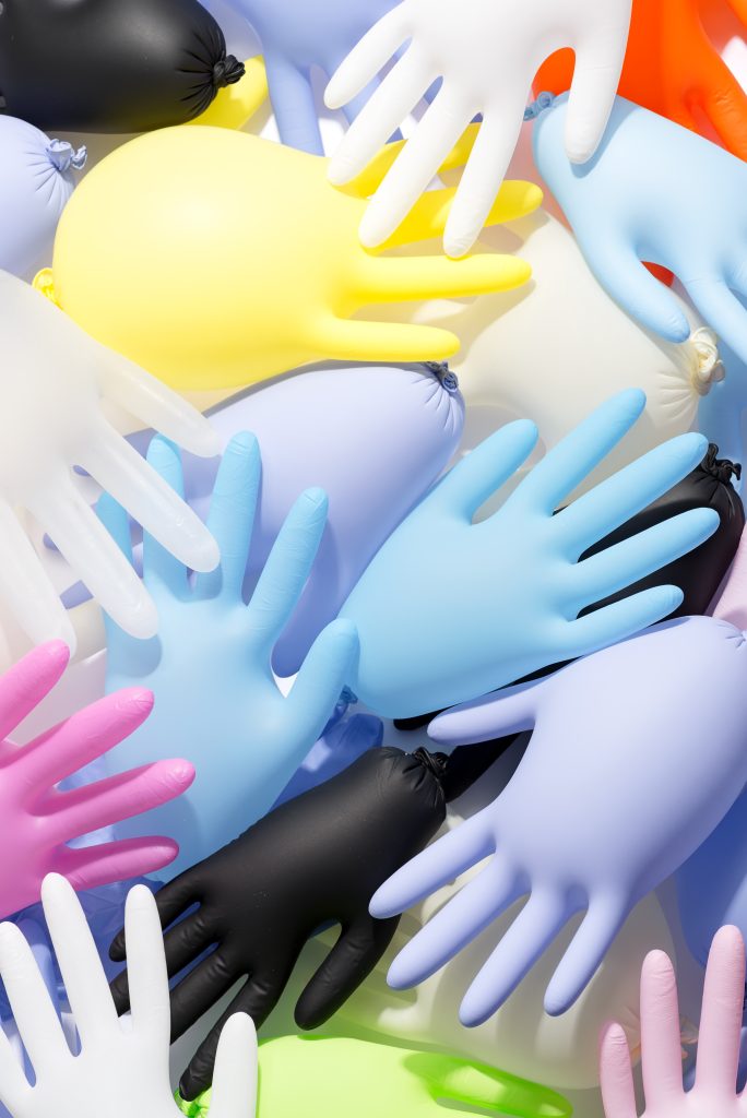 Set of multicolored rubber medical gloves background.