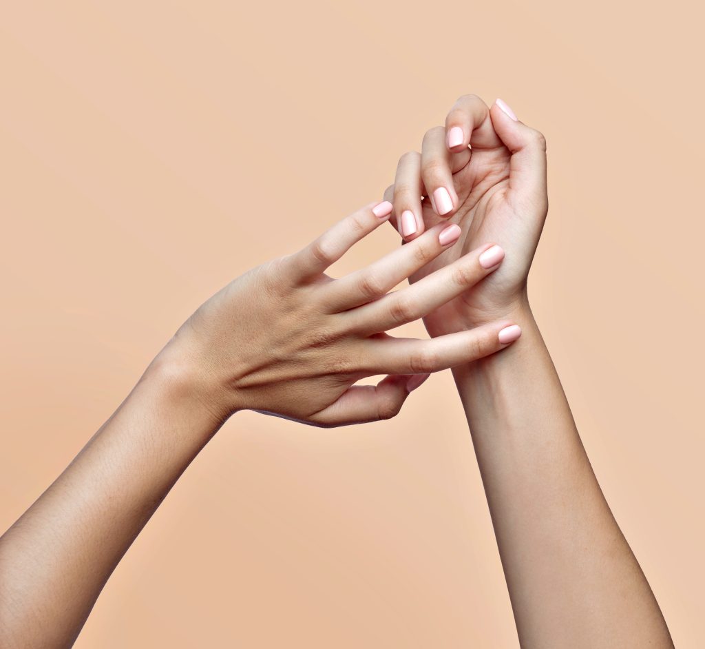 close up of a young woman hands with nail polish