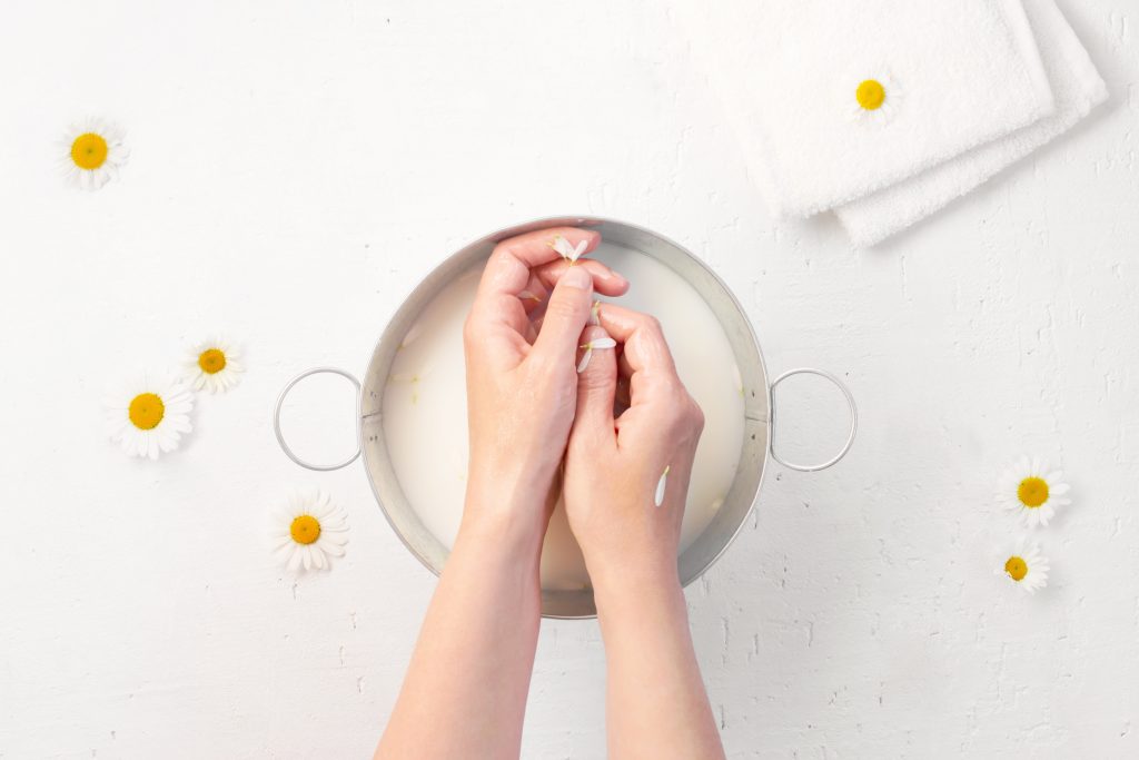 Hand skin care with natural cosmetics at home, home organic spa salon, top view. Repair Dry Cuticles.