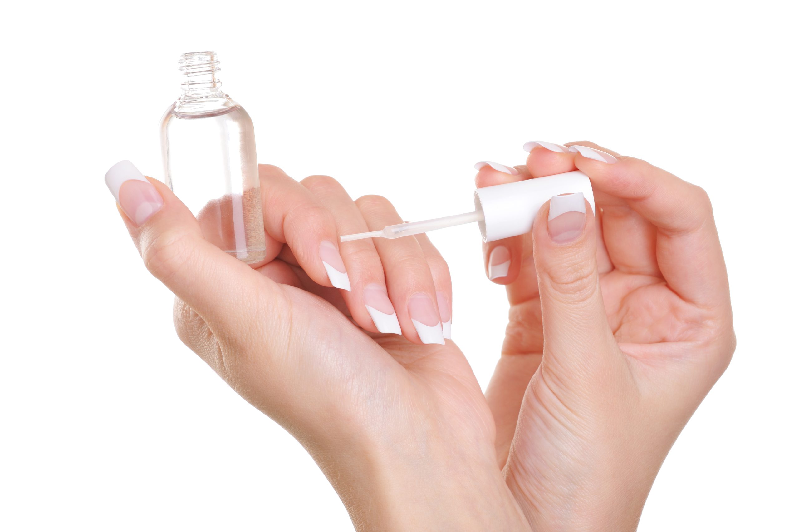 repair dry cuticles. Woman applying clear nail vanish on her fingernails - macro shot. Repair Dry Cuticles
