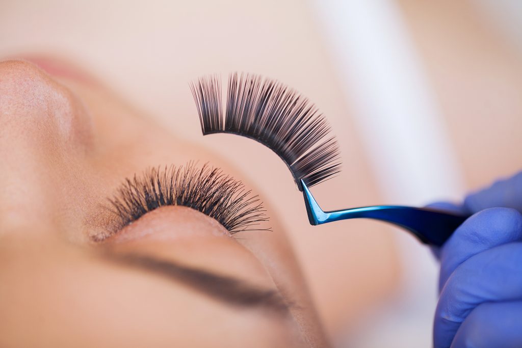 Best Lash Glue. Lash Glue Top Picks. Eyelashes extensions. Fake Eyelashes. Eyelash Extension Procedure. Professional stylist lengthening female lashes. Master and a client in a beauty salon.