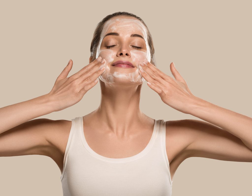 Soap face woman clean skin beauty. Color background. Brown