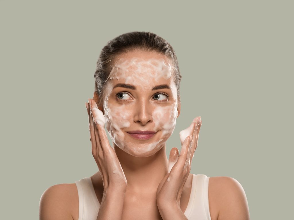 Soap face woman clean skin beauty. Color background. Green