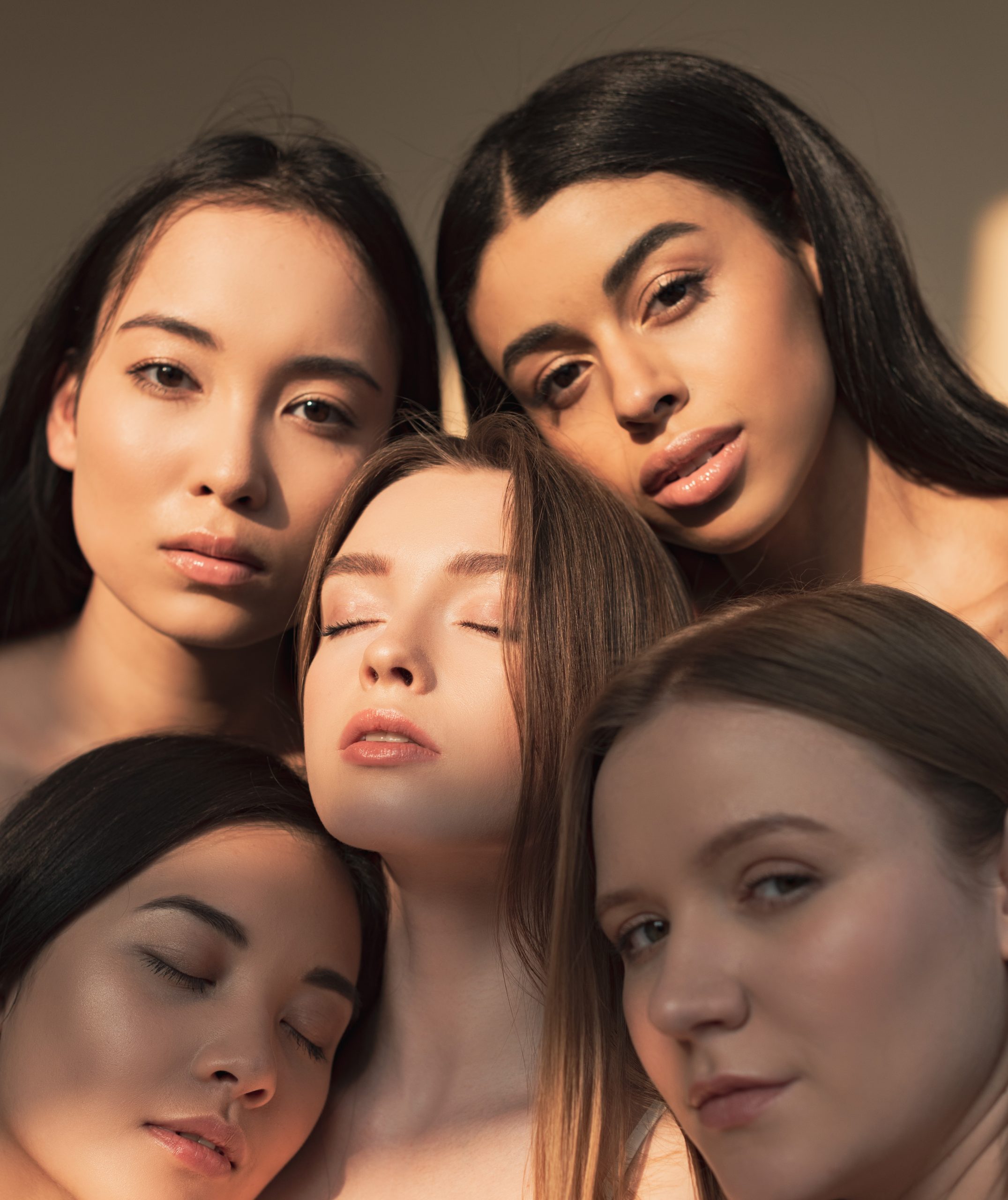 five dreamy multicultural girls posing at camera in sunlight. skin types. skin type. skincare.