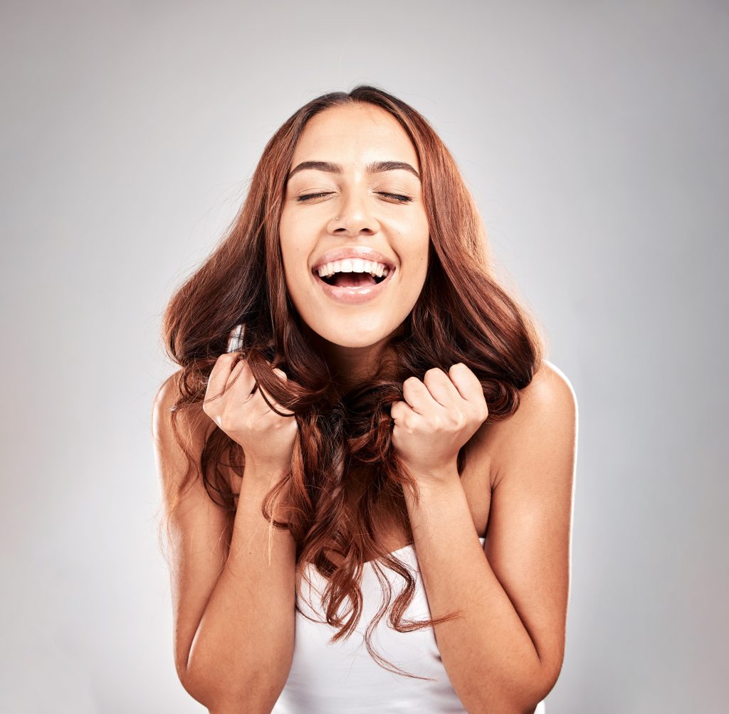 Healthy hair, hands and woman in studio for beauty, hair and salon treatment on grey background. Ha.