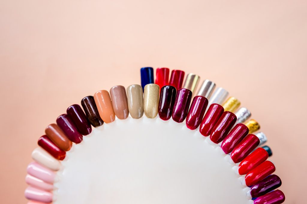Nail Polish Finishes. Nail polish samples in different bright colors. Colorful nail lacquer manicure swatches. Top view of nail art wheel palette.