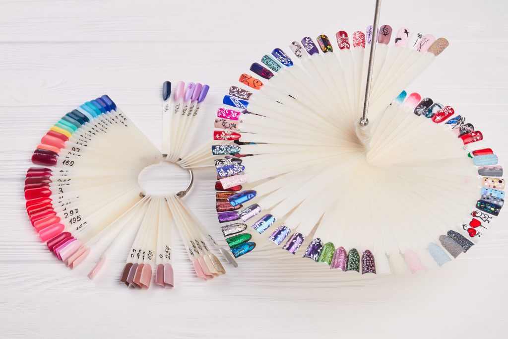 Nails art design samples. Manicure nail polish colors palette. Nails polish testers in different colors.
