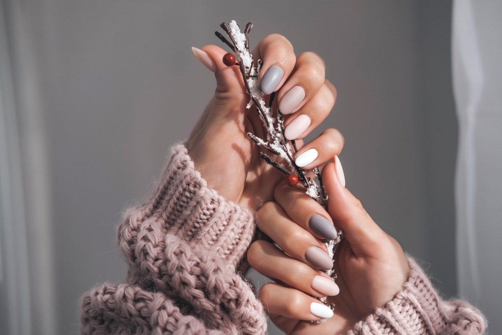 Women's hands with a beautiful matte oval manicure. nail polish. manicure. pedicure.