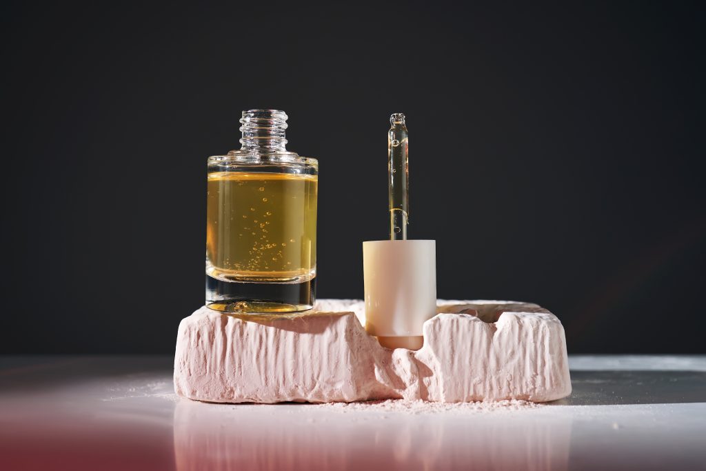 Bottle with yellow serum in Steel Life. High quality photo.