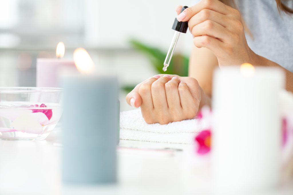 Woman making manicure when resting at home.