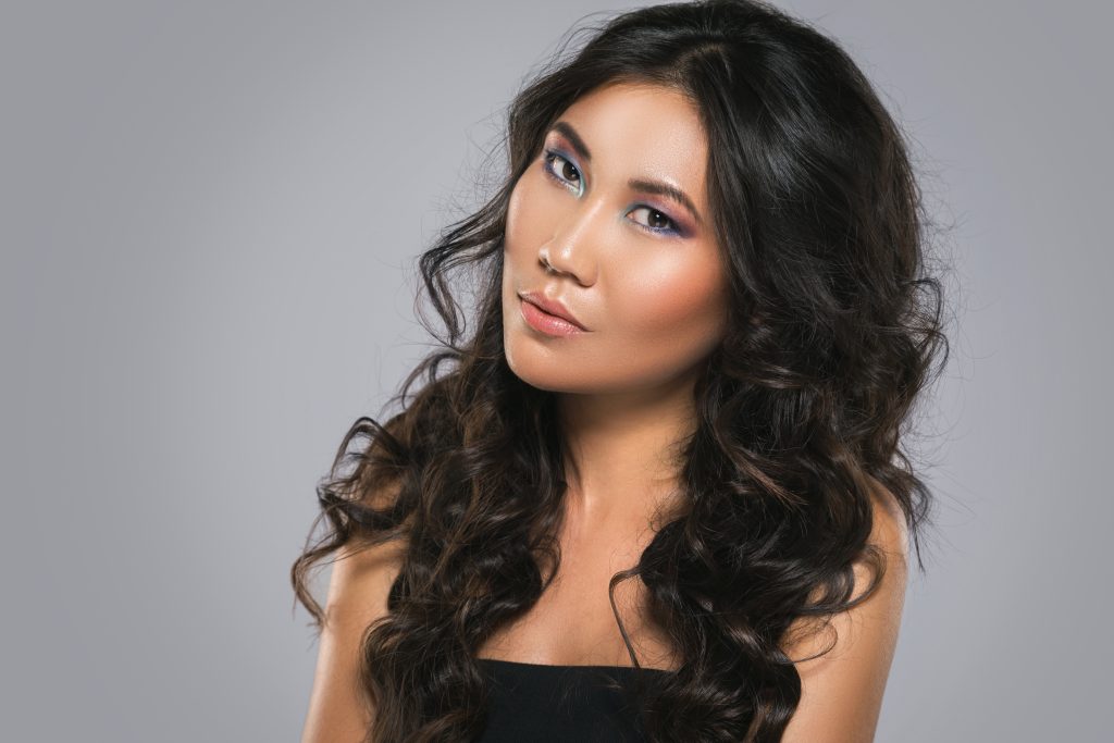 Portrait of Young asian woman with a beautiful curly hair