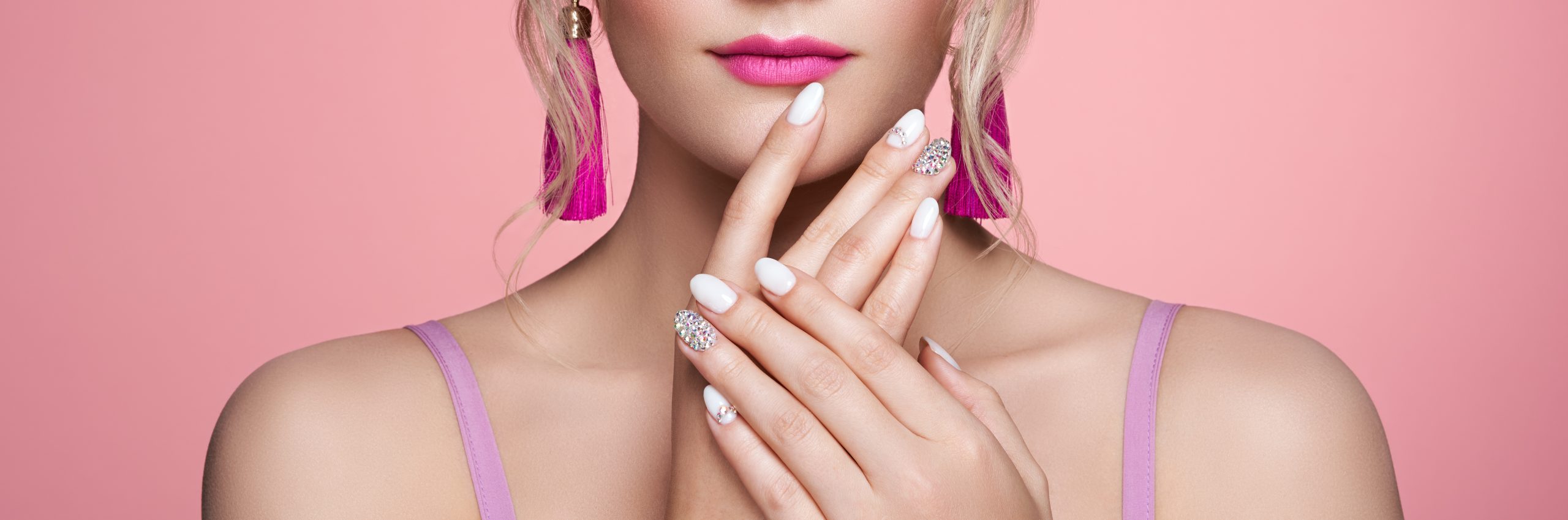Beauty Woman with perfect Makeup and Manicure. Glamour Girl with Jewelry. Pink Lips and Nails. Precious Stones and Silver. Beauty girls Face isolated on light Background. Fashion photo