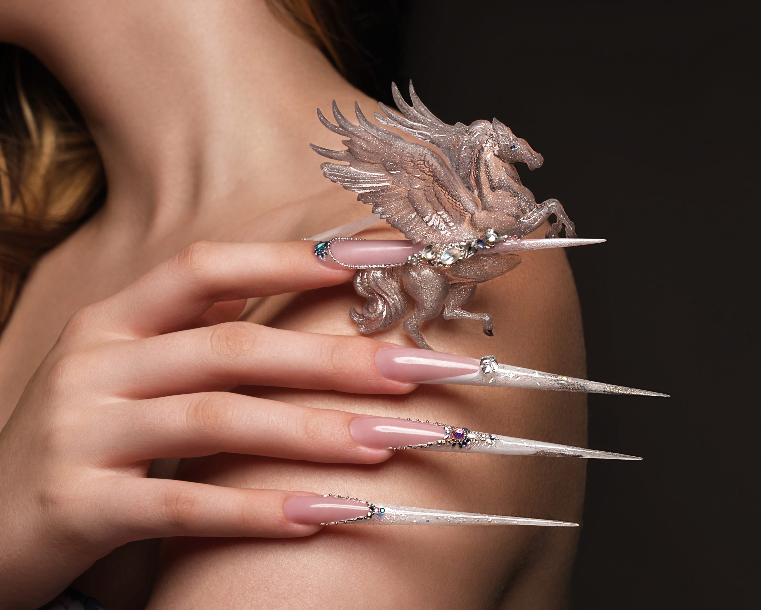 Acrylic nails. Creative design of nails on female hands. Art manicure. Photo taken in studio.