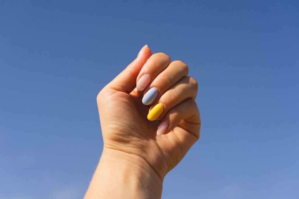 Yellow and blue manicure. Girl with manicure of ukrainian flag colors. Flag of Ukraine, freedom independence concept