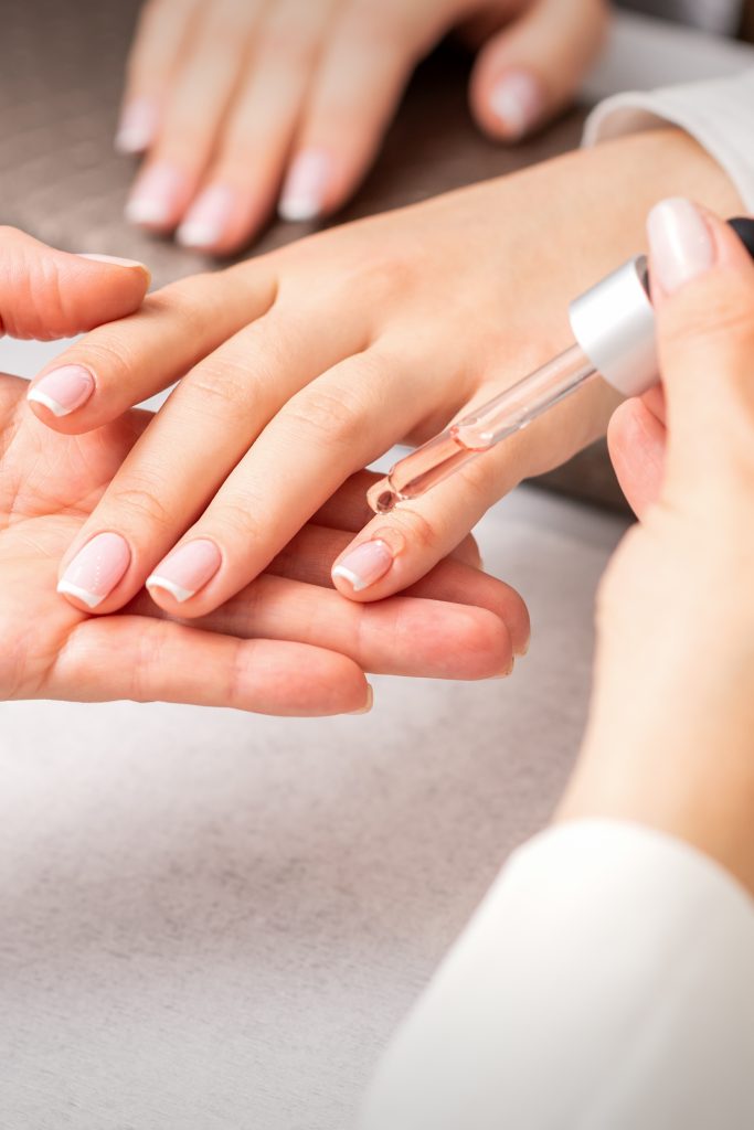 Tips to Maintain Gel Nails. Applying nail oil for healthy nails. DIY nail care.
