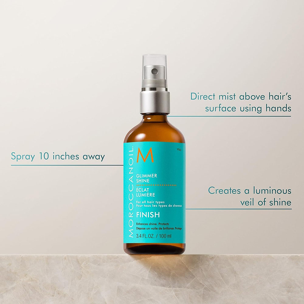 Infographic showing how to apply Moroccanoil Glimmer Shine Spray by spraying 10 inches away from hair to create a luminous veil of shine.