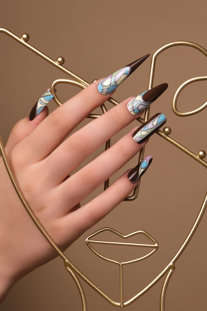 Creative design of nails on female hands. Art manicure. Photo taken in studio
