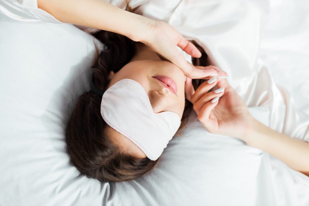High view of woman in sleeping mask.