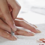 Woman take off her Press-On Nails at home